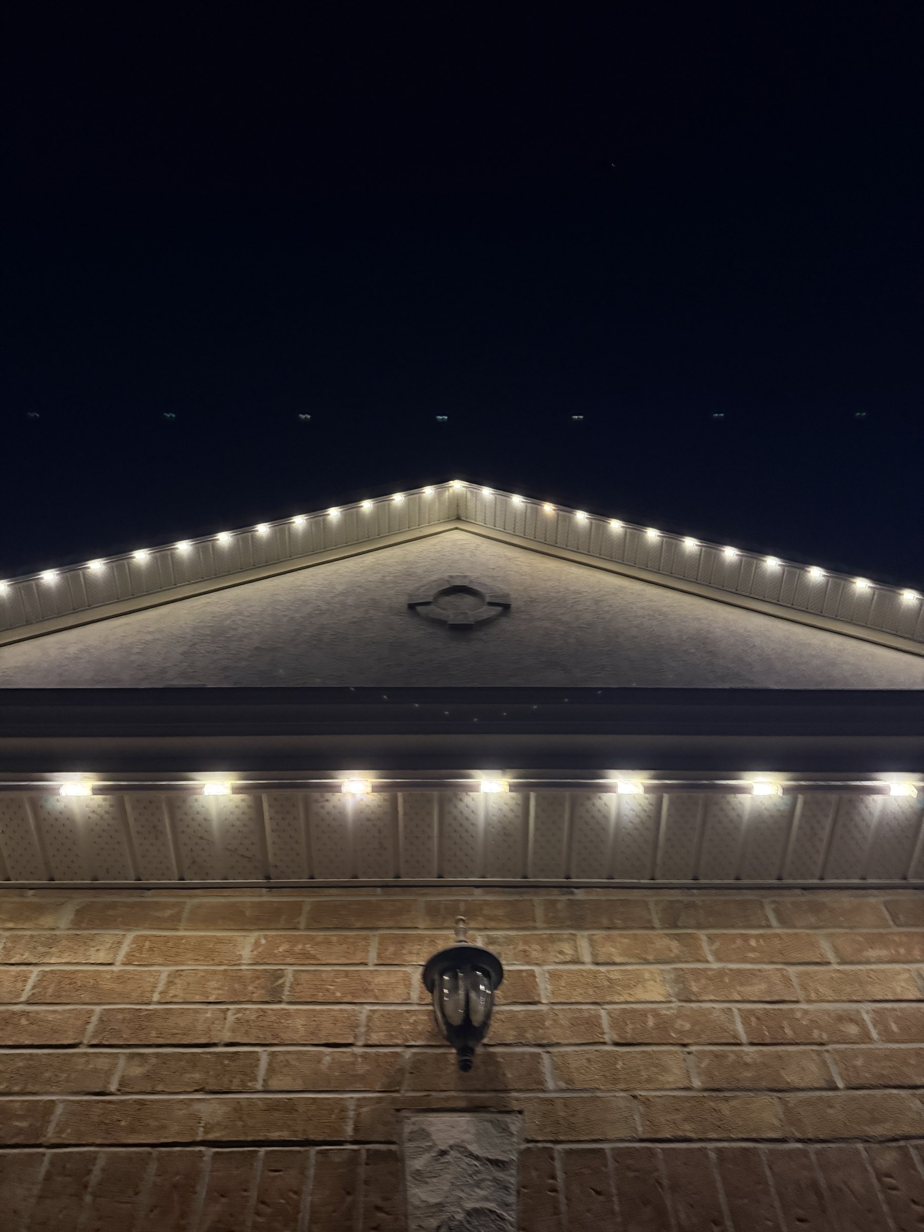 Warm-white Wise light positioned directly at the centre of a roof peak