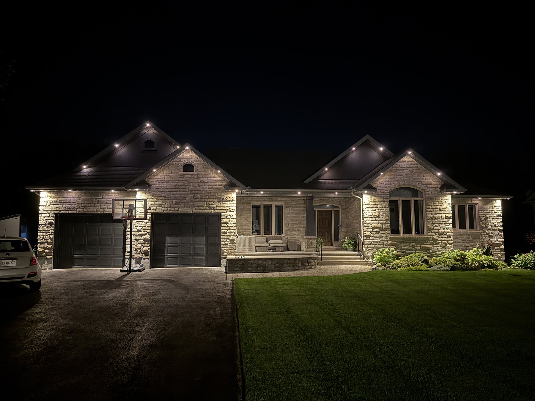 Warm white permanent roofline lighting on an Ottawa bungalow